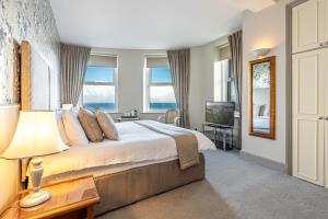 a bedroom with a large bed and a television at Best Western Walton Park Hotel in Clevedon