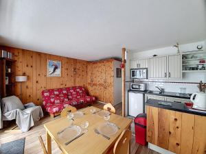 a kitchen and living room with a table in a room at APPARTEMENT ST JEAN D'AULPS - PROCHE PIED DES PISTES - PROCHE MORZINE - Riam 6 in Saint-Jean-d'Aulps