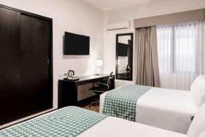 Voodi või voodid majutusasutuse Wyndham Costa del Sol Piura toas