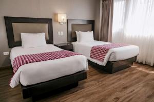 Voodi või voodid majutusasutuse Wyndham Costa del Sol Piura toas