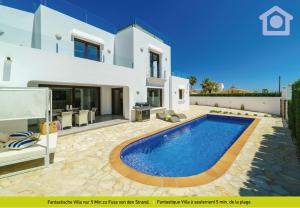 a villa with a swimming pool in front of a house at Solhabitat Sport in Moraira