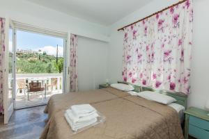 Ένα ή περισσότερα κρεβάτια σε δωμάτιο στο Lido Apartments Tolo