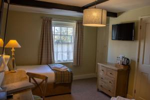 A bed or beds in a room at The Green Dragon
