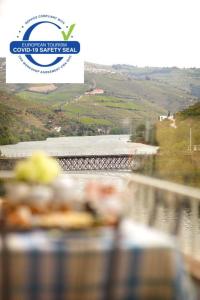 a view of a bridge over a river with a sign at Cantinho D'Os Reais in Pinhão