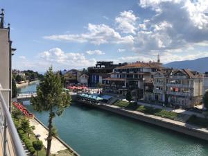 a view of a river with houses and buildings at Apartment N & N in Struga