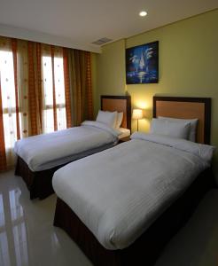 Un pat sau paturi într-o cameră la The Venue Resident