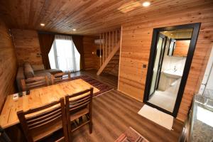 a wooden room with a wooden table and chairs at İRBEÇ APART & BUNGALOW in Demre