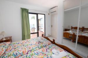 a bedroom with two beds and a large window at Ladera Panorama 22 in Málaga