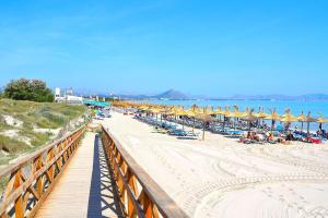 a beach with chairs and umbrellas and people on it at 039 Casa Marimar ETV8486 by Mallorca Charme in Muro