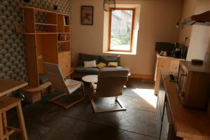 a living room with a couch and a chair at Joli appartement confortable rénové style cosy in Saint-Martin-de-la-Porte