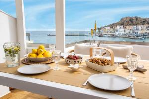 a table with food and a view of the ocean at Olia Boutique Apartments in Karpathos