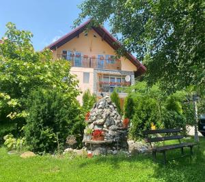 a house in the background with a bench in front of it at Villa Nina in Campina