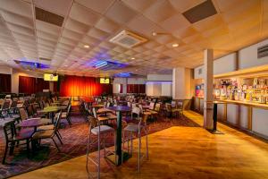 a restaurant with tables and chairs and a bar at Seahawk Lodge in Whitley Bay