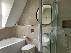 a bathroom with a toilet and a sink and a shower at 1820 Boutique Rooms & Suites in Blackpool