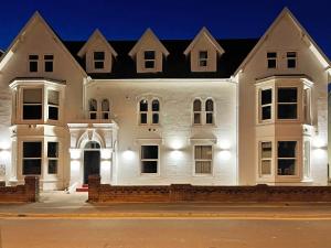 a large white house with a black roof at 1820 Boutique Rooms & Suites in Blackpool