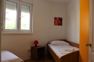 a bedroom with two twin beds and a window at Tomislav in Makarska