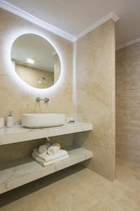 a bathroom with a sink and a mirror at Aegean Villas in Poros