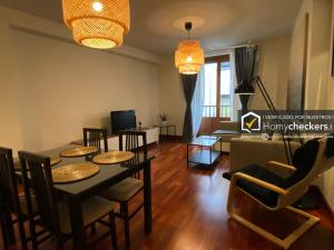 a living room with a table and chairs and a couch at HomyAT Prior Romo, Plaza Mayor in Salamanca