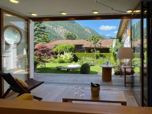 a living room with a view of a patio at Landhaus Renata - Wendelstein in Bayrischzell
