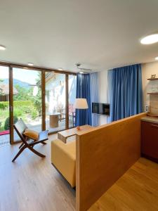 a living room with a couch and a tv at Landhaus Renata - Wendelstein in Bayrischzell