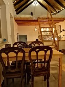 a dining room with a wooden table and chairs at Villa Vista in Sesimbra