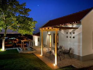 a white house with a patio at night at Villa Vista in Sesimbra