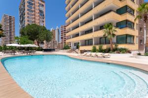 a large swimming pool in front of a building at Halley Hotel & Apartments Affiliated by Meliá in Benidorm