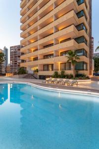 a large swimming pool in front of a building at Halley Hotel & Apartments Affiliated by Meliá in Benidorm