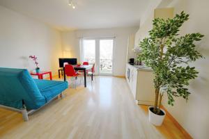 a living room with a blue couch and a table at HITrental Stauffacher Apartments in Zürich +55 photos