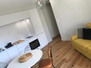 ein Wohnzimmer mit einem Tisch und einem gelben Sofa in der Unterkunft Appartements de Standing - Panate in Corte