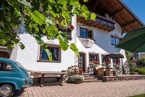 a blue car parked in front of a house at Apartments Christa App B2 in Ortisei