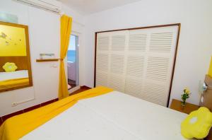 a bedroom with a bed and a mirror at Pé na Praia by OCvillas in Albufeira