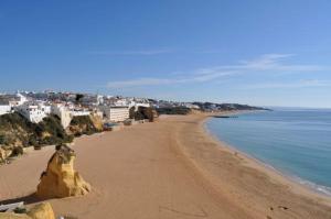 a view of a beach with buildings and the ocean at Pé na Praia by OCvillas in Albufeira