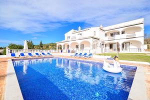 a villa with a swimming pool and a house at Vila Vale Mouro by OCvillas in Faro