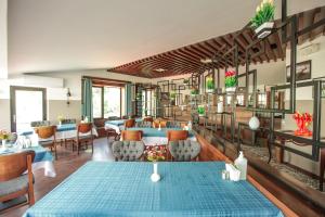 a dining room with blue tables and chairs at The Life Hotel & Spa in Çankaya