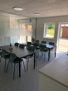 una sala con mesas y sillas en un aula en Den Gode Søvn en Øster Hurup