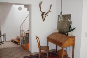 a dining room with a table and a chair at Bed & Breakfast Bodensee mit Herz in Stockach