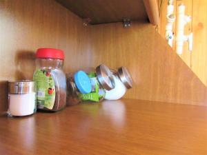 a shelf with jars of food on top of a counter at Arpa Valley Cabin in Yeghegnadzor