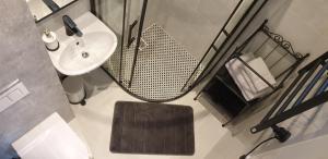 a small bathroom with a sink and a mirror at Lighthouse Apartment Šventosios Vartai in Palanga