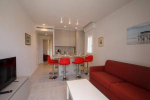 ein Wohnzimmer mit einem roten Sofa und roten Stühlen in der Unterkunft Casa Plauto con appartamento grande in Bellaria-Igea Marina