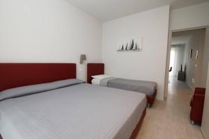a hotel room with two beds and a room with at Casa Plauto con appartamento grande in Bellaria-Igea Marina