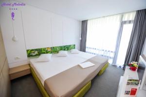 Postel nebo postele na pokoji v ubytování Hotel Melodia