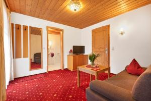 a living room with a couch and a table at Pension Zum Rechen in Bodenmais