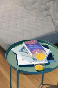 a glass table with a book and a wine glass at HITrental Town Hall Apartments in Basel