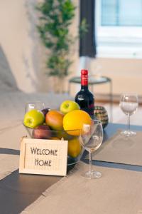 a bowl of fruit on a table with a welcome home sign at HITrental Town Hall Apartments in Basel