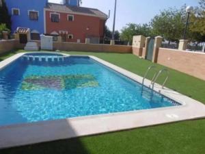 a swimming pool in the middle of a yard at Casa Rozalejo - A Murcia Holiday Rentals Property in San Javier