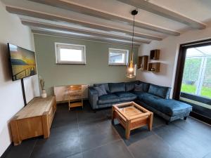 a living room with a couch and a table at Haus Wunschlos Kirchenweg in Monschau