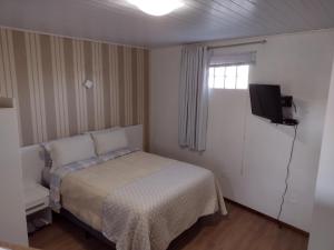 Ένα ή περισσότερα κρεβάτια σε δωμάτιο στο Pousada Encantos da Serra