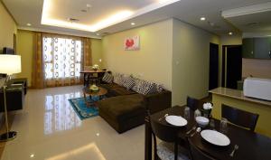 a living room with a couch and a table at The Venue Resident in Kuwait