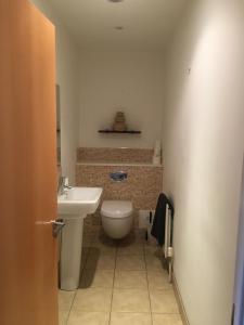 a bathroom with a toilet and a sink at Riverside Townhouse, Only 20 Minutes from Brighton and Worthing in Shoreham-by-Sea